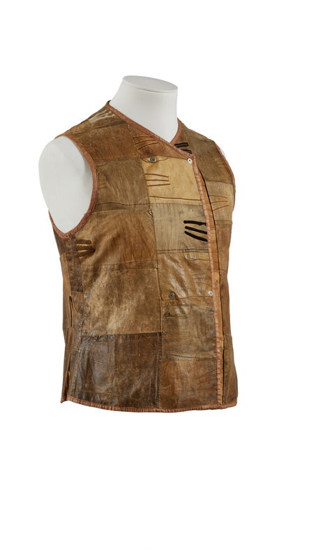 Brown leather patchwork style leather waistcoat made of gloves on a mannequin.